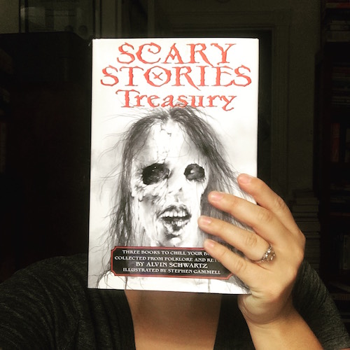Carmen Machado holding up the book Scary Stories Treasury